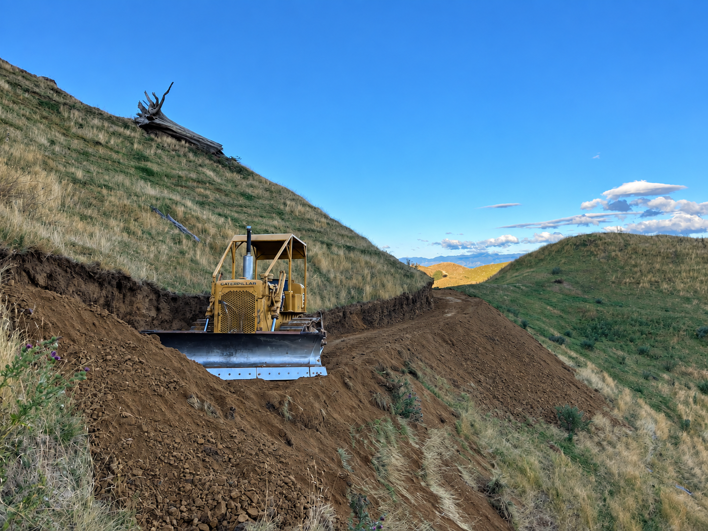 Earthmoving work on a rural hillside